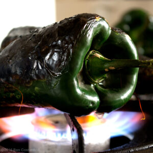 roasting poblano pepper over an open flame