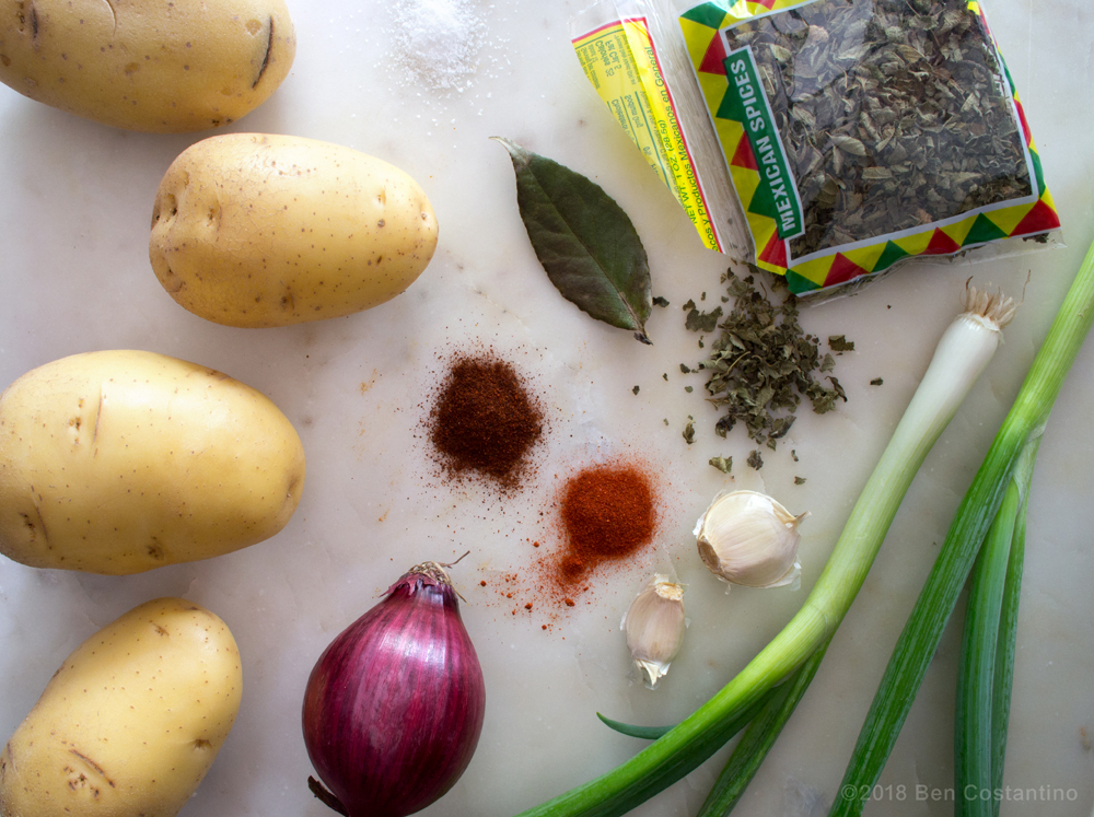 Ingredients for homefries Yellow potatoes, red onion, chili powder, bay leaf, smoked paprika, garlic, Mexican oregano, scallion.