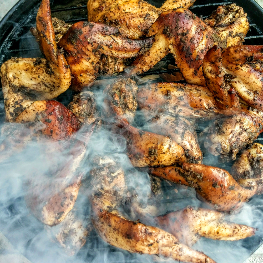 jerk chicken cooking on the grill