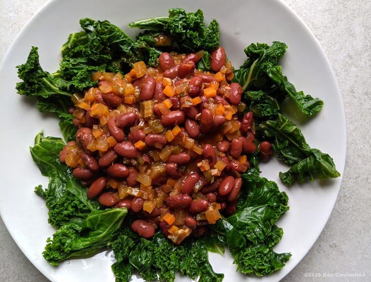 Andouille vegan red beans with blanched kale.