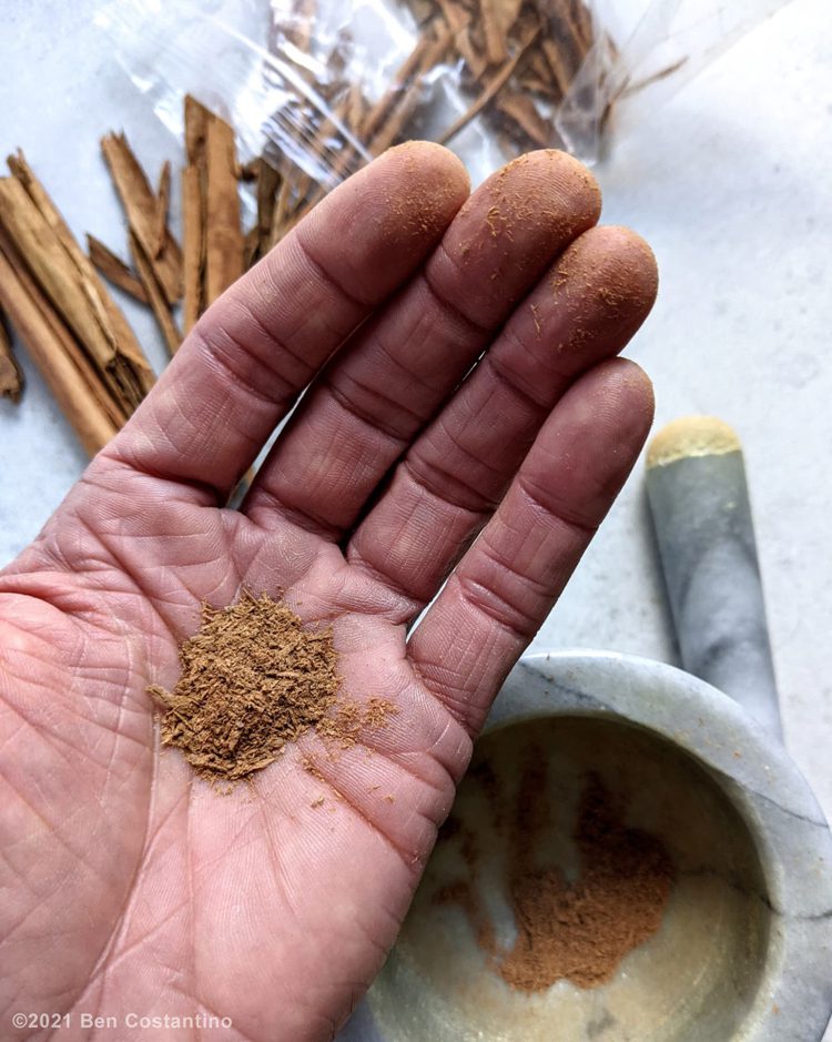 grinding Mexican cinnamon in a mortar and pestle