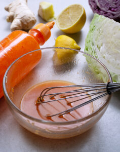 skinny coleslaw ingredients with sriracha sauce and lemon juice